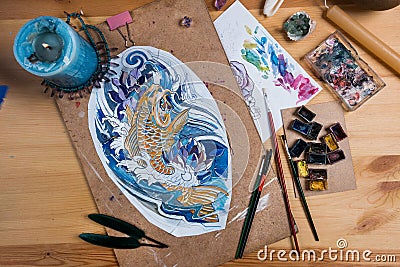 Creative artist table on which is sketch a fish. Stock Photo