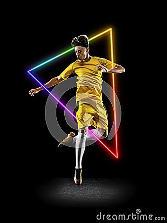 Creative artwork of prfessional male football player in motion over neon geometric element isolated over black Stock Photo