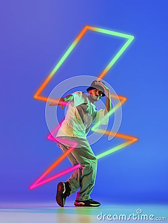 Creative artwork of prfessional male hip-hop dancer in motion over neon lightning element over blue background Stock Photo