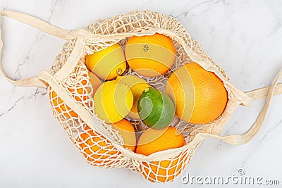 Creative background made of summer tropical fruits with grapefruit, orange, tangerine, lemon, lime on white marble background. Stock Photo