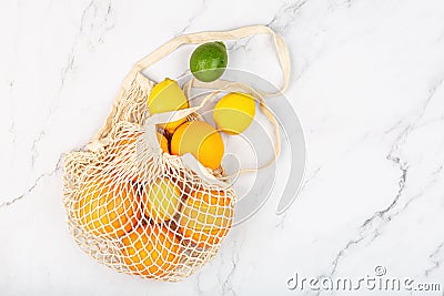 Creative background made of summer tropical fruits with grapefruit, orange, tangerine, lemon, lime on white marble background. Stock Photo