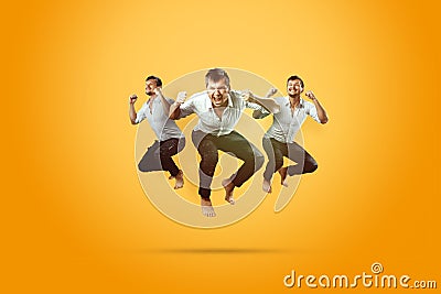 Creative background. Young, handsome man, jumping for joy, very much happy, yellow background. The concept of altero, joy, Stock Photo