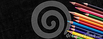 Creative banner with Multicolor pencils on black canvas background, education frame concept with copy space Stock Photo