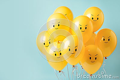 Creative banner with yellow balloons with angry unhappy faces con blue background. Social issues self-identity business teamwork Stock Photo