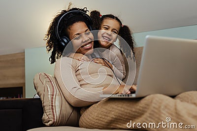 Creative black mother and daughter working on school project, using modern laptop Stock Photo