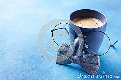 Creative breakfast on Happy Fathers Day with funny face from cup of coffee, eyeglasses and bowtie. Stock Photo