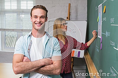 Creative business people at work by blackboard Stock Photo