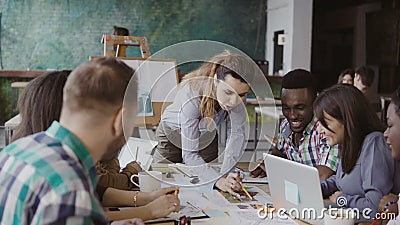 Creative business team discussing architectural project. Brainstorming of mixed race group of people in trendy office. Stock Photo