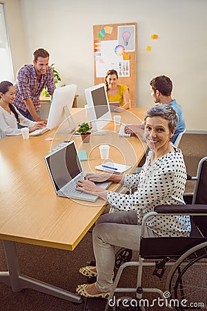 Creative casual businesswoman in wheelchair Stock Photo