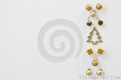 Creative Christmas. Greeting card layout flat lay, top view. Christmas toys of gold color Stock Photo