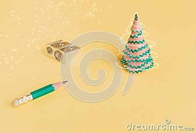 Creative christmas tree. Pencil, shavings and sharpener on a yellow background. Christmas concept in office Stock Photo