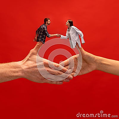 Creative collage with hands. Young man and woman shaking hands symbolizing partnership, agreement and cooperation. Stock Photo