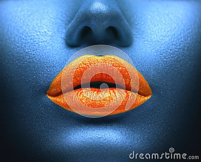 Creative colorful makeup. Bodyart, lipgloss on sexy lips, girls mouth. Orange lips on blue skin Stock Photo