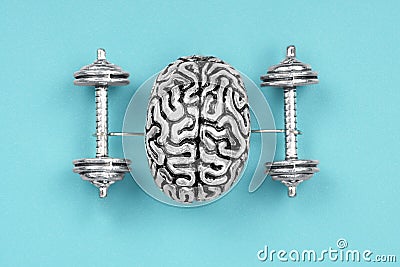 Creative composition made of a steel copy of a human brain lifting dumbbells. Stock Photo