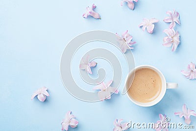 Creative composition with morning coffee and pink flowers on blue pastel background top view. Flat lay style. Stock Photo