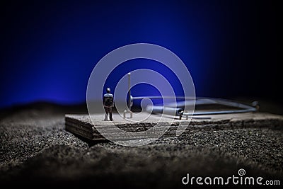 Creative concept. Artwork decoration of mousetrap on dark toned foggy background. Mousetrap captured a man Stock Photo
