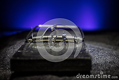 Creative concept. Artwork decoration of mousetrap on dark toned foggy background. Mousetrap captured a man Stock Photo