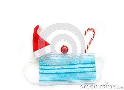 Creative concept of the new year amid coronavirus. christmas medical flatlay. Medical mask, gift, Christmas decorations on a white Stock Photo