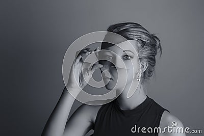 Creative conversion of woman holding a shard of broken mirror Stock Photo