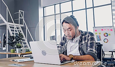 Creative designer feel sleepy while working hard with laptop at modern office.workplace lifesyle concept Stock Photo