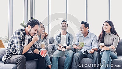 Creative designer take coffee break at office cafeteria. multiethnics employee sitting at sofa and talking and have fun Stock Photo