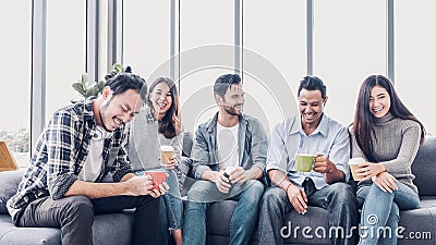 Creative designer take coffee break at office cafeteria. multiethnics employee sitting at sofa and talking and have fun Stock Photo