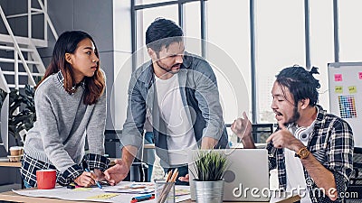 Creative designer team argument at casual meeting table and walk out from meeting in modern office.tea,m conflict concept Stock Photo