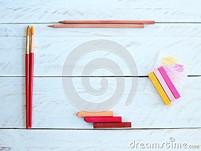 Creative desktop with pastels, brushes and wooden pencils Stock Photo