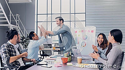 Creative director team lead clap hand with designer team at meeting table.discussion idea in creative office Stock Photo