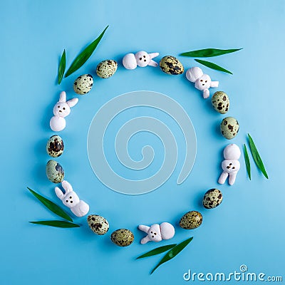 Creative Easter wreath made from motley quail eggs, pink marshmallow bunny Stock Photo