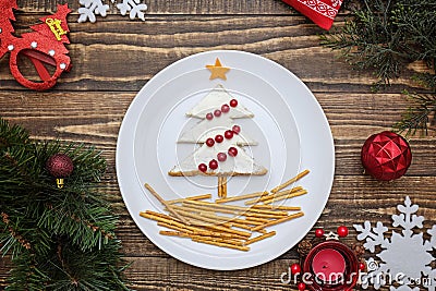 Creative edible christmas tree, food art. Food for kids and festive table. Tree made from bread with cream cheese Stock Photo