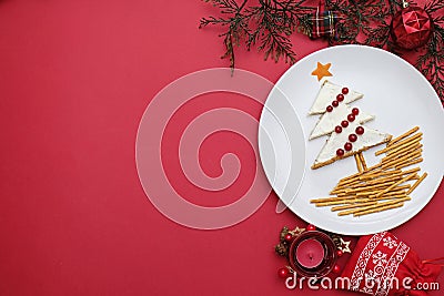 Creative edible christmas tree, food art. Food for kids and festive table. Tree made from bread with cream cheese Stock Photo