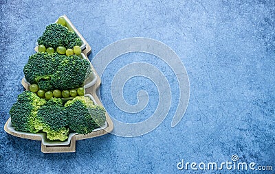 Creative edible Christmas tree made of fresh broccoli.Holiday ideas. New year food background top view . holiday, celebration, Stock Photo