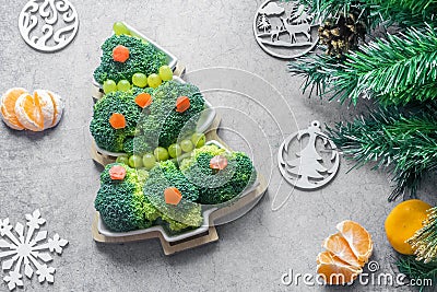 Creative edible Christmas tree made of fresh broccoli.Holiday ideas. New year food background top view . holiday, celebration, Stock Photo