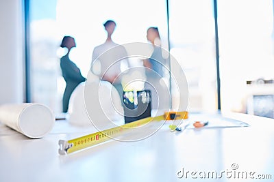 Creative engineering designer discuss building plans in a corporate business. Measure tape on a table or desk in an Stock Photo