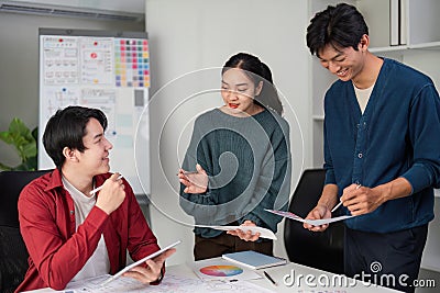 Creative Exchange in UIUX Design. Professionals sharing insights and approaches to enhance product interface and user Stock Photo