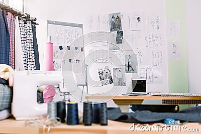 Creative fashion designer desk or workplace with sewing equipment, fabrics, templates, modern stylist inspirational Stock Photo