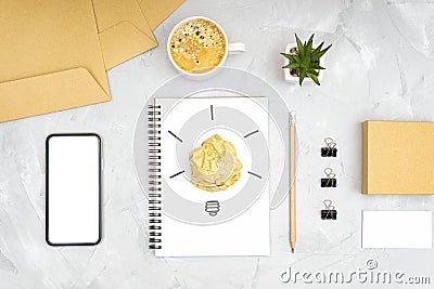 Creative flat lay composition. Glowing light bulb made of crumpled paper ball on the office desk. Stock Photo