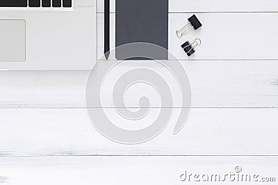 Creative flat lay photo of workspace desk. Top view office desk with laptop, mock up notebooks on white wooden background. Stock Photo