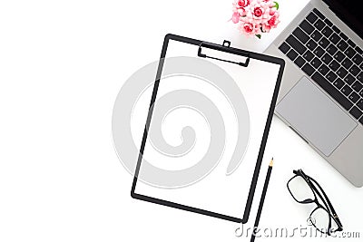 Creative flat lay photo of workspace desk. Top view office desk with laptop, glasses, pencil, blank clipboard and plant on white Stock Photo