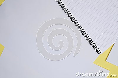 Creative flay lay, table top for students, office, business work.Spiral Notebook and white sheet on a yellow background Stock Photo