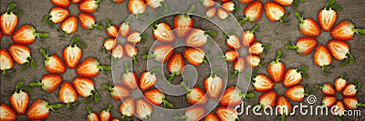 Creative flowers made of strawberries cut from below lit on a stone background Food concept Banner Stock Photo