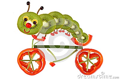 Creative food concept. Funny little caterpillar on a bicycle ma Stock Photo