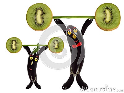 Creative food concept. Two funny eggplant raise the bar of kiwi Stock Photo