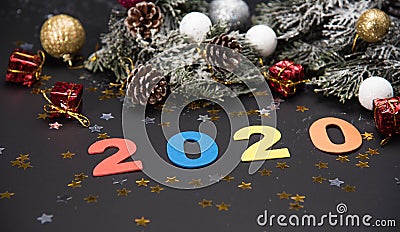 Creative 2020 frame made of Christmas fir branches on white wooden background with red decoration, pine cones. Xmas and New Year. Stock Photo