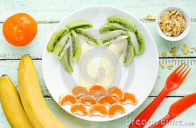 Creative fruit dessert with kiwi, banana and tangerine shaped pa Stock Photo