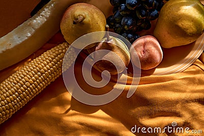 Creative fruits photography: group of grapes, apple, pear, peach, corn and melon on the orange plate under trendy Stock Photo