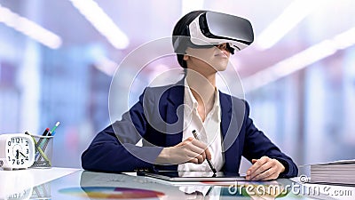 Creative graphic designer in vr goggles drawing tablet in office, modern device Stock Photo