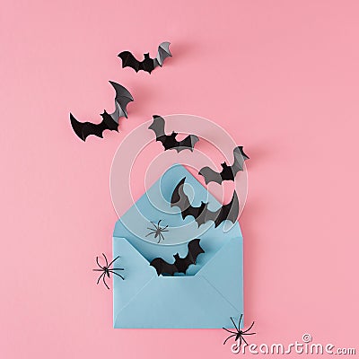 Creative Halloween horror concept with spiders, bats and paper envelope on pink background. Stock Photo