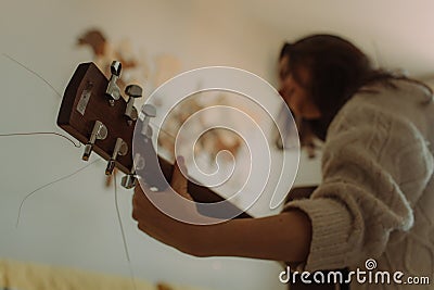 Creative hobby. Talented young female musician sit in armchair alone compose instrumental song using classic guitar. Copy space Stock Photo